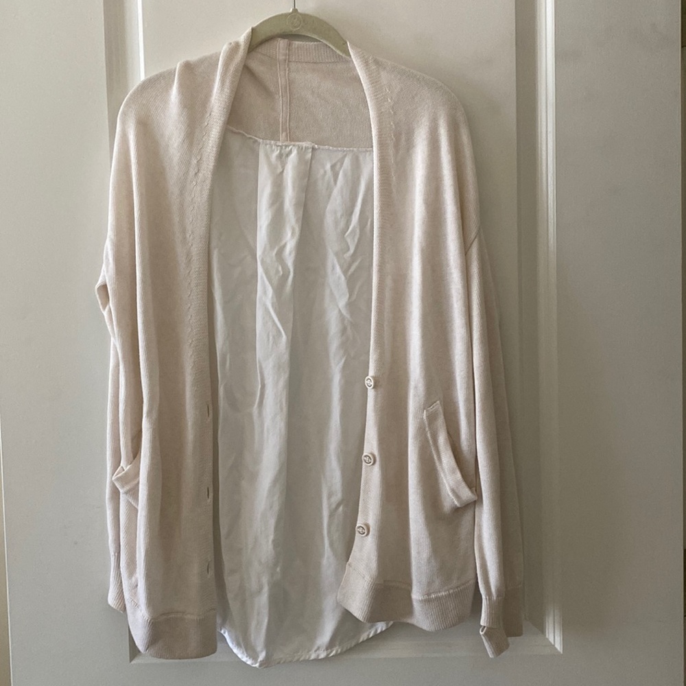 A Lululemon cream and white cardigan size small